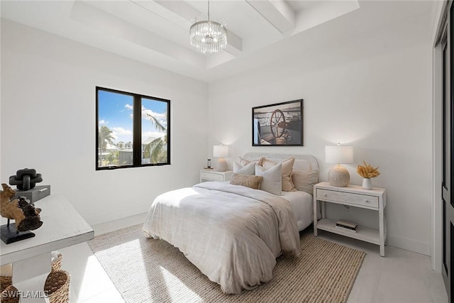 bedroom featuring a chandelier and a tray ceiling