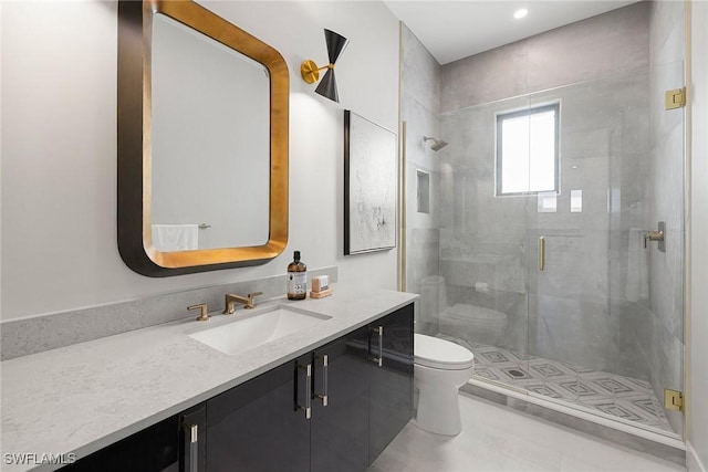 bathroom with tile patterned floors, vanity, an enclosed shower, and toilet