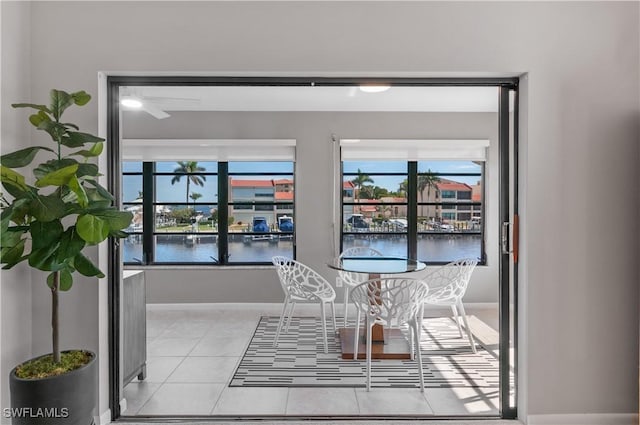 tiled dining area with a water view and plenty of natural light