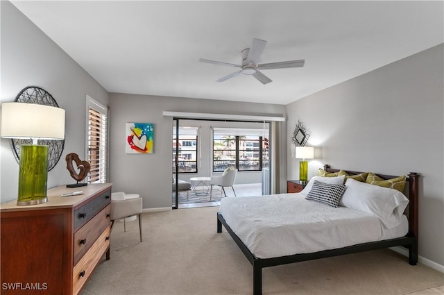 bedroom with light colored carpet, a ceiling fan, and baseboards