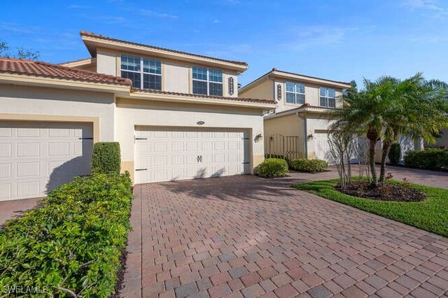 mediterranean / spanish-style home with a garage