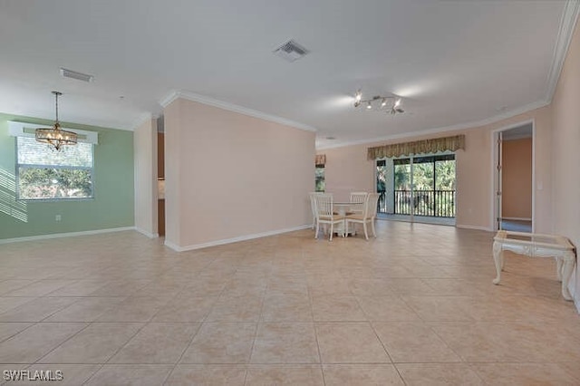 tiled spare room with crown molding and a chandelier