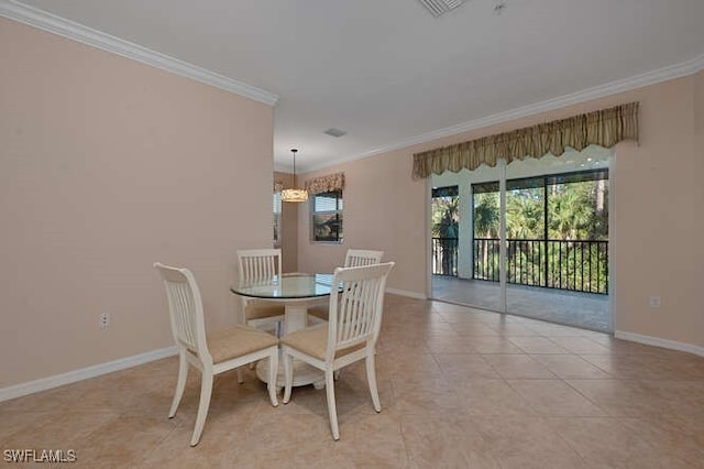 tiled dining area featuring crown molding and a notable chandelier