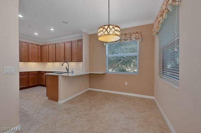 kitchen with sink, tasteful backsplash, ornamental molding, kitchen peninsula, and pendant lighting