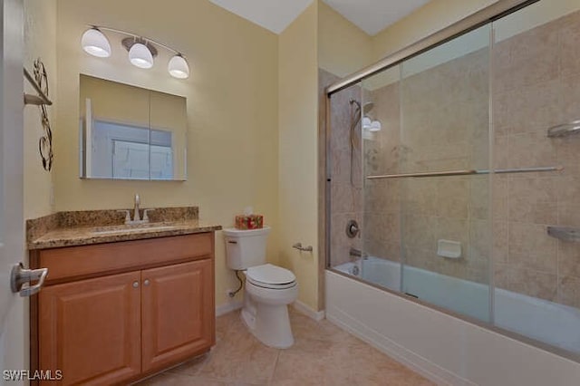 full bathroom with vanity, combined bath / shower with glass door, tile patterned floors, and toilet