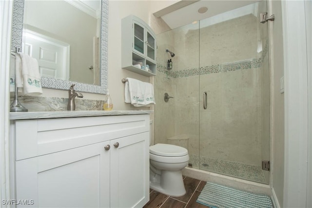 bathroom with vanity, toilet, walk in shower, and crown molding