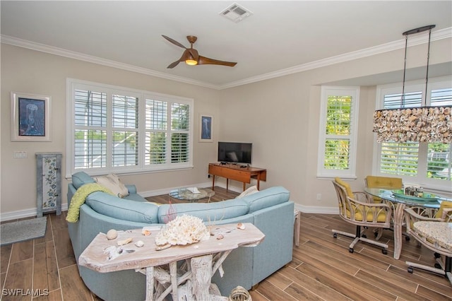 living room featuring ceiling fan and ornamental molding