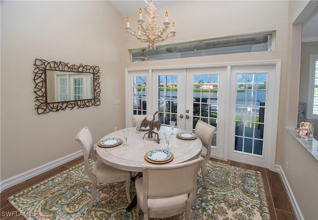 dining area with french doors, dark hardwood / wood-style floors, and a notable chandelier