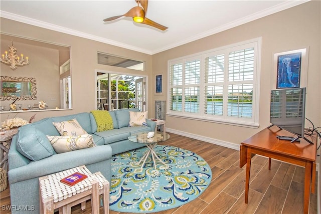 living room featuring ceiling fan with notable chandelier and ornamental molding