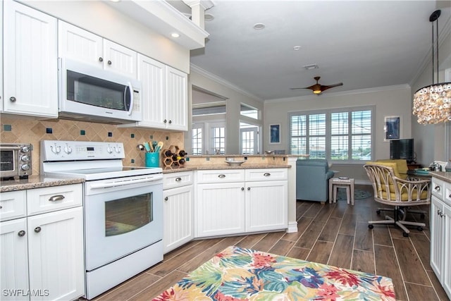 kitchen with tasteful backsplash, white appliances, ceiling fan, pendant lighting, and white cabinets