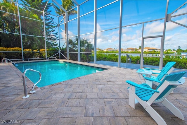 view of swimming pool with glass enclosure and a patio