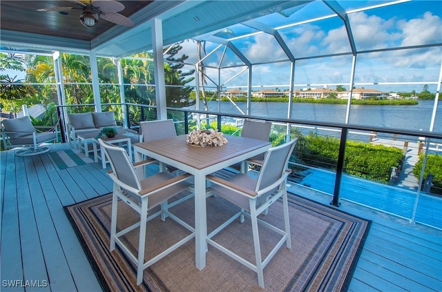 exterior space featuring ceiling fan and a water view