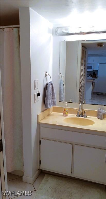 bathroom with tile patterned flooring and vanity