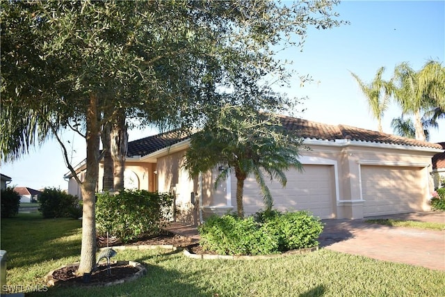 view of front facade with a front yard and a garage