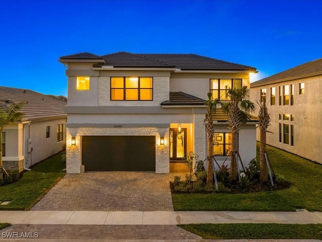 view of front of home featuring a front lawn and a garage