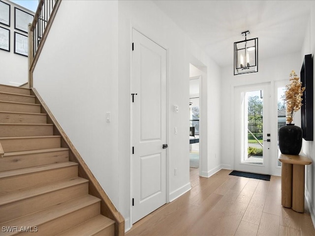 foyer featuring a chandelier and light hardwood / wood-style flooring