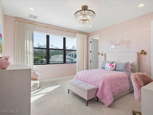 bedroom with light colored carpet and an inviting chandelier