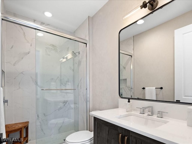 bathroom featuring vanity, toilet, and an enclosed shower