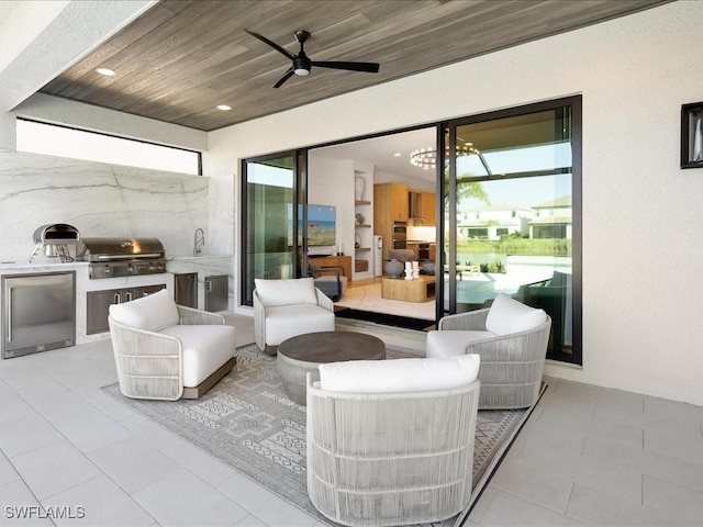 view of patio featuring ceiling fan, area for grilling, and sink