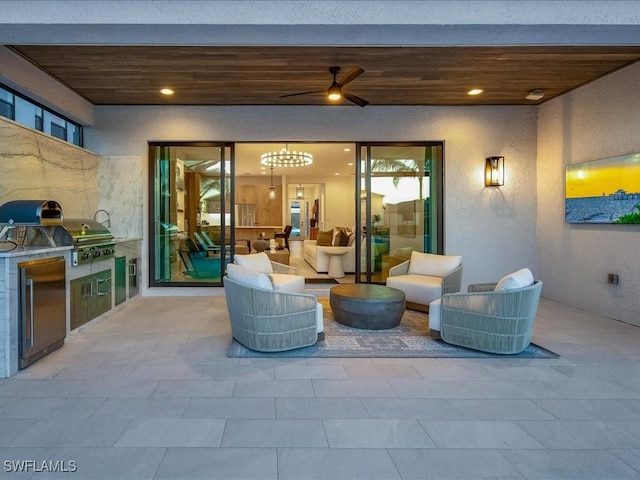 view of patio featuring a grill, ceiling fan, and an outdoor kitchen