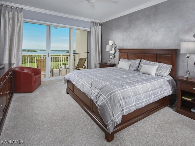 carpeted bedroom featuring ceiling fan, a water view, crown molding, and access to outside