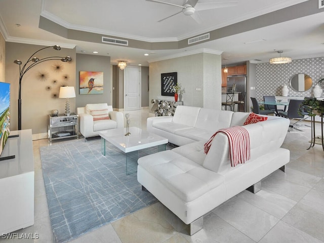 living room featuring ceiling fan, a raised ceiling, and crown molding