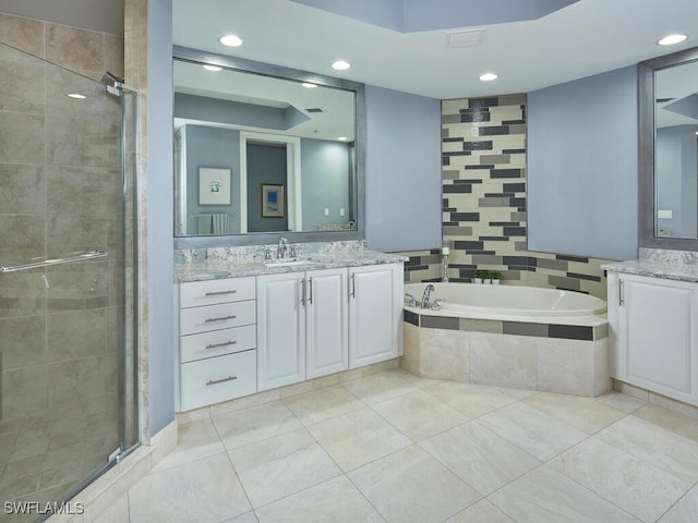 bathroom featuring vanity and shower with separate bathtub