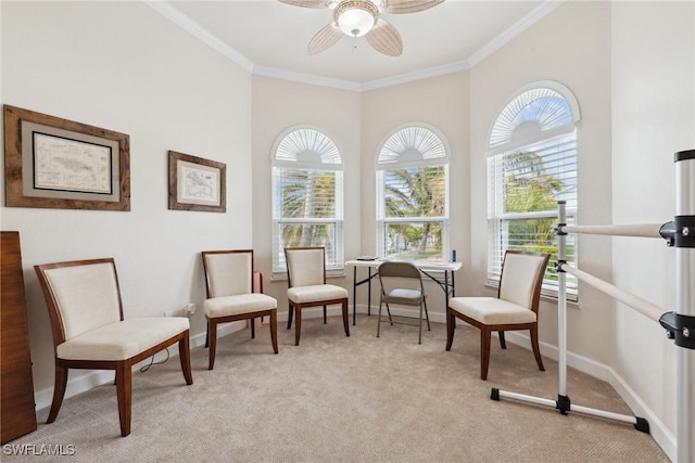 living area featuring ornamental molding, light carpet, baseboards, and a ceiling fan