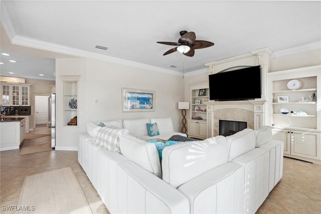 living room featuring ceiling fan, light tile patterned floors, recessed lighting, a high end fireplace, and crown molding