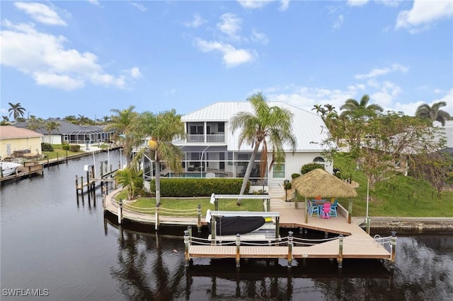 view of dock featuring a water view, a yard, and boat lift