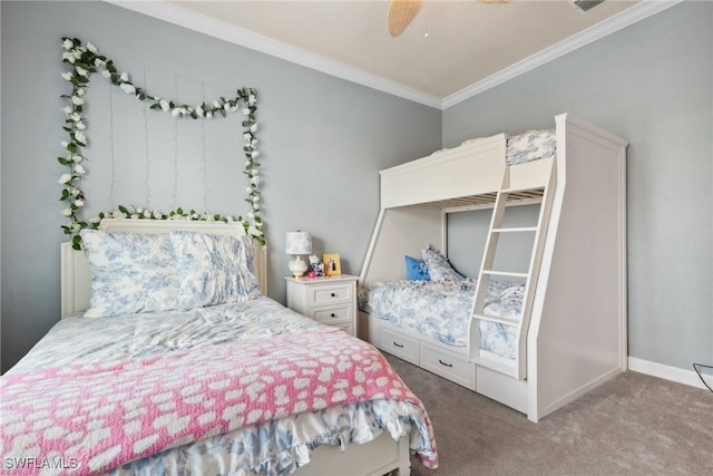 carpeted bedroom with ornamental molding, baseboards, and a ceiling fan