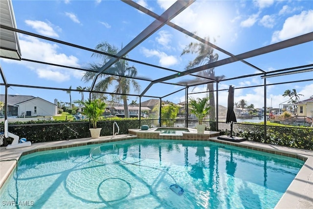 view of swimming pool featuring glass enclosure, a pool with connected hot tub, and a residential view