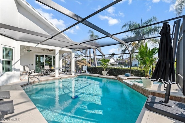 view of swimming pool featuring a pool with connected hot tub, a lanai, and a patio