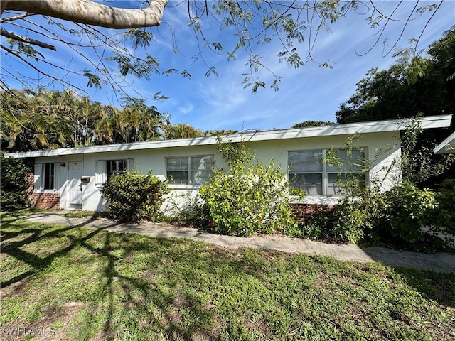 exterior space with a yard and stucco siding