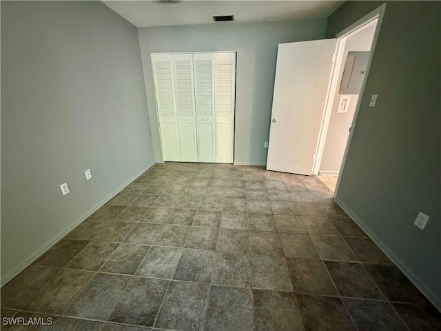 unfurnished bedroom featuring baseboards, visible vents, and a closet