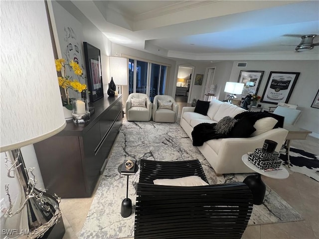 living room with crown molding and a tray ceiling