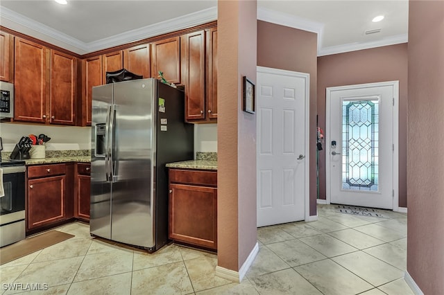 kitchen featuring light stone counters, crown molding, light tile patterned flooring, and appliances with stainless steel finishes