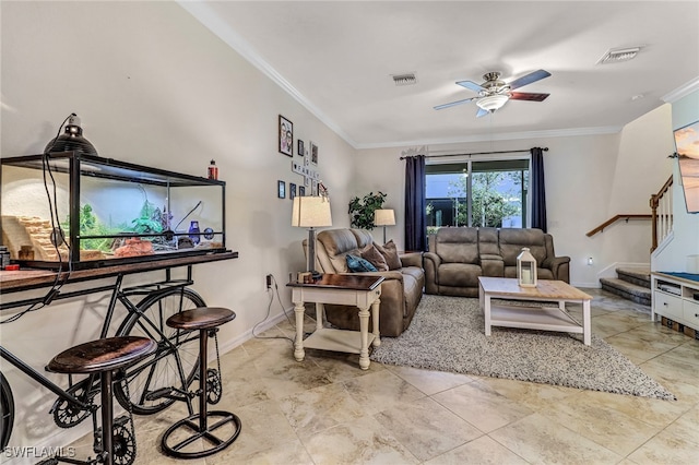 living room with ceiling fan and ornamental molding