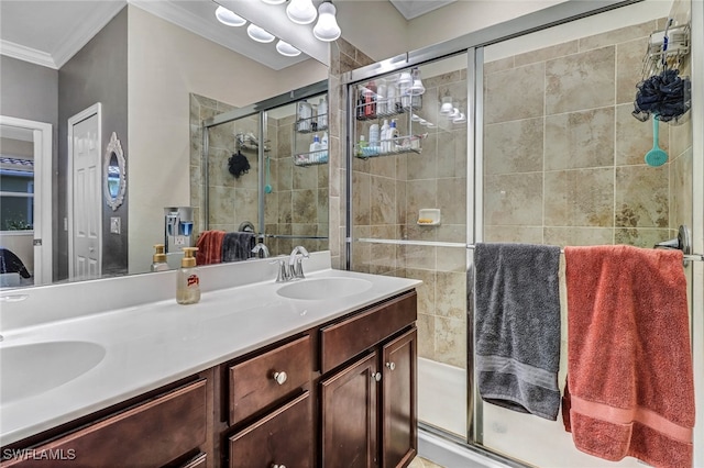 bathroom with vanity, crown molding, and a shower with shower door