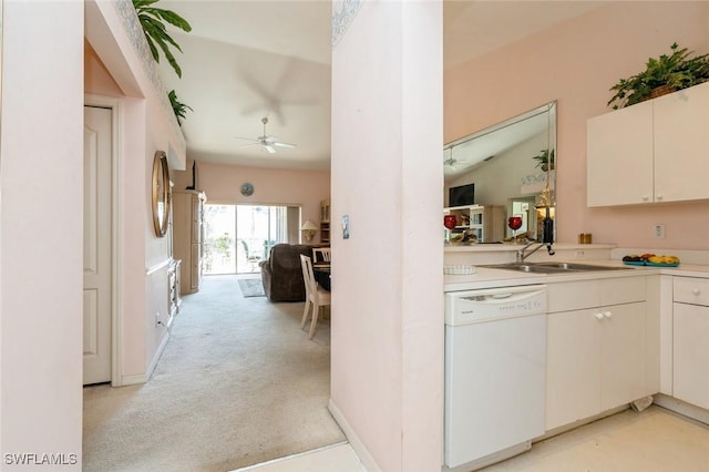 kitchen featuring ceiling fan, sink, white dishwasher, light colored carpet, and white cabinets