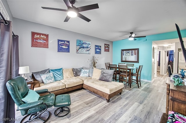 living room featuring ceiling fan and light hardwood / wood-style flooring