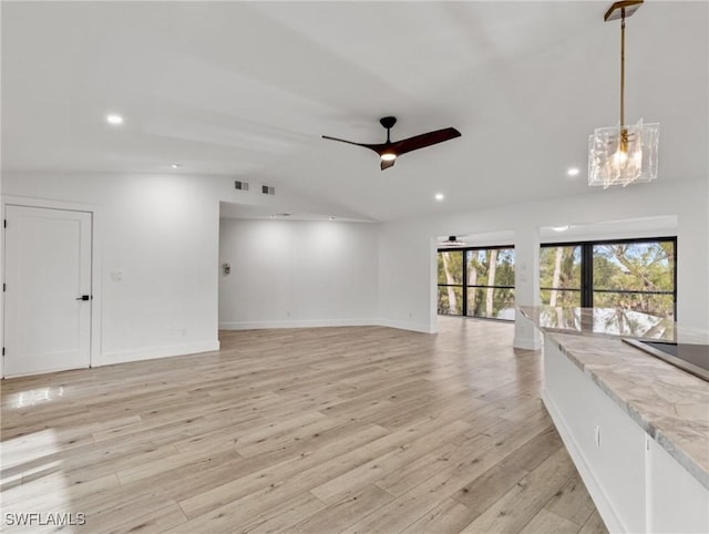 unfurnished living room with ceiling fan, lofted ceiling, and light hardwood / wood-style flooring