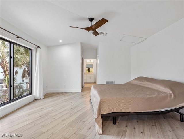 bedroom with ensuite bath, light hardwood / wood-style flooring, and ceiling fan