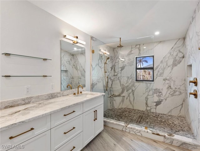 bathroom with vanity and tiled shower