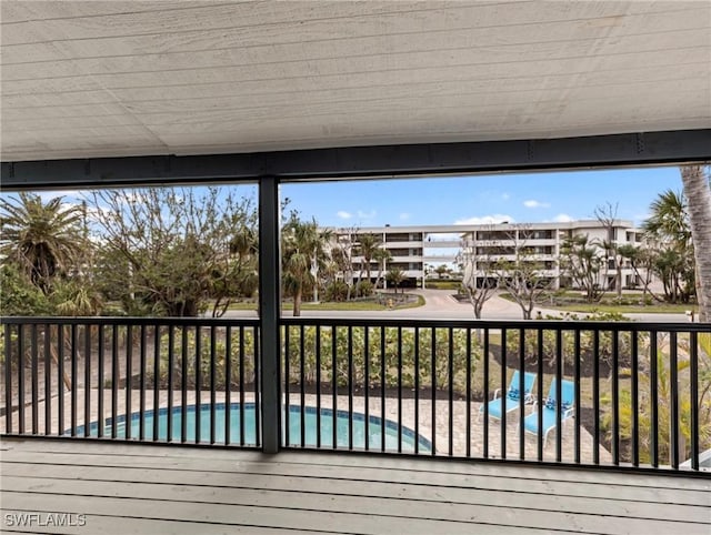 deck featuring a fenced in pool