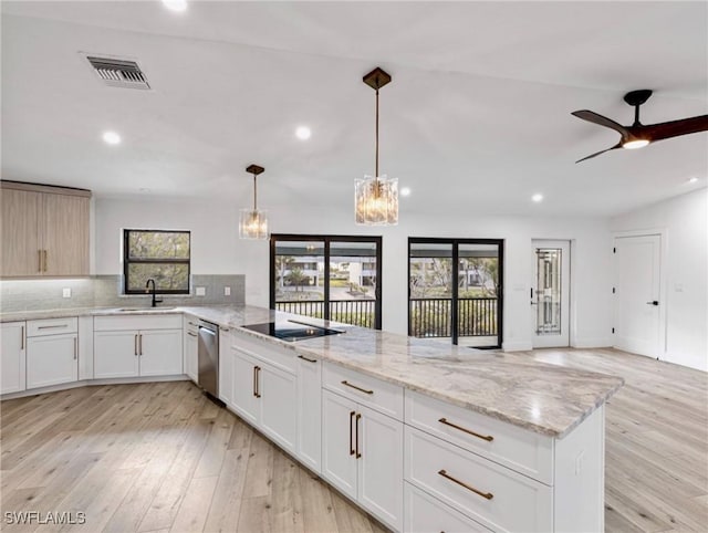 kitchen with ceiling fan with notable chandelier, decorative light fixtures, tasteful backsplash, white cabinets, and stainless steel dishwasher