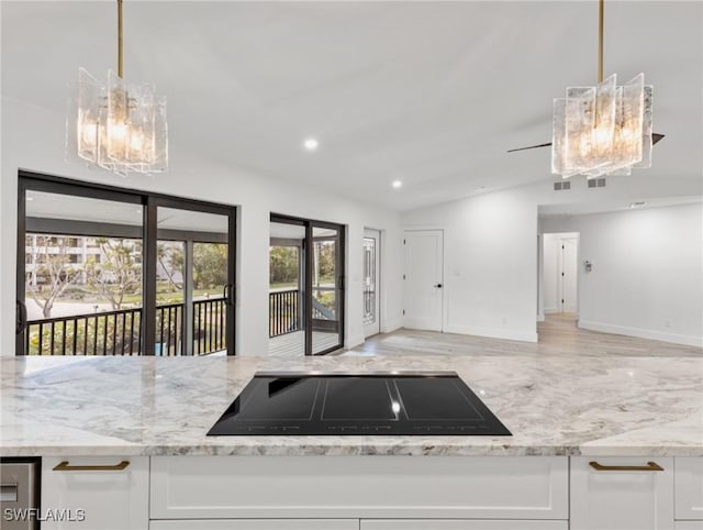 kitchen with white cabinetry, pendant lighting, black electric cooktop, and lofted ceiling