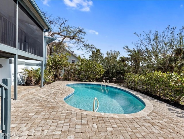 view of pool with a sunroom