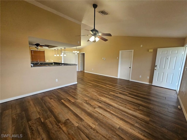 unfurnished living room with dark hardwood / wood-style flooring, ceiling fan with notable chandelier, and lofted ceiling