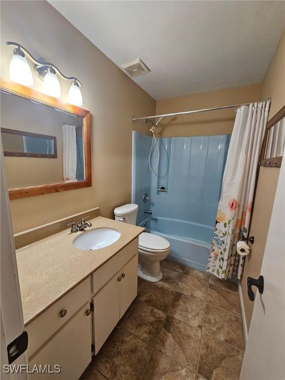 full bathroom with shower / tub combo, vanity, and toilet